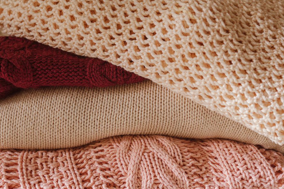 Layered knit scarves and cozy autumn textures.