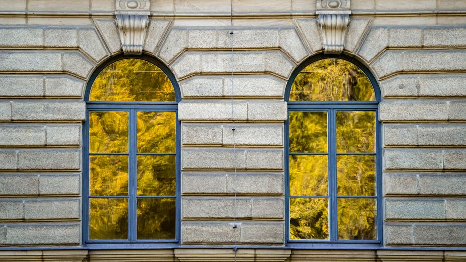 Pumpkins and gourds decorate charming autumn windowsill.
